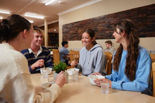 Male and female students enjoying lunch in the boarding dining room.